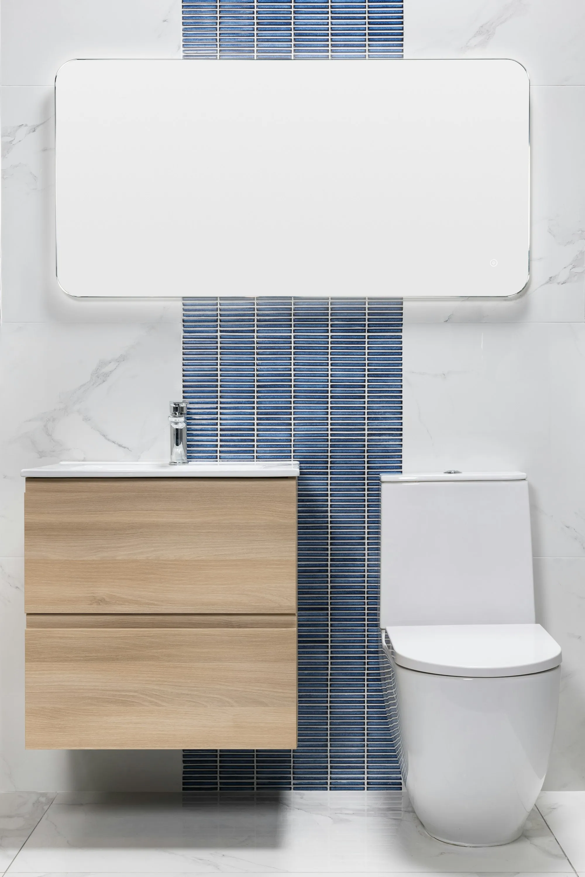 A bathroom with a mirror, vanity and daylight