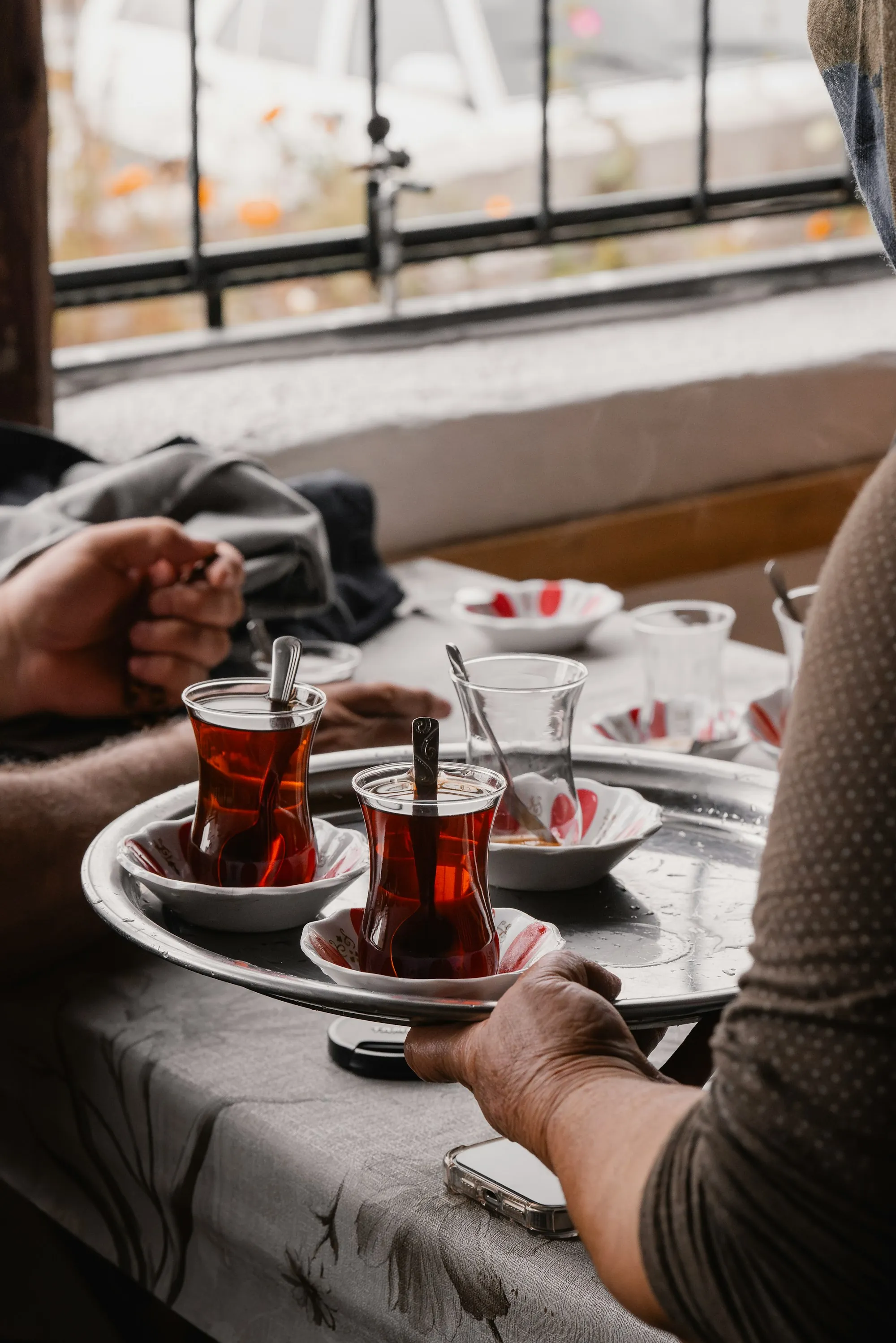 Two people sitting and talking over plates of food