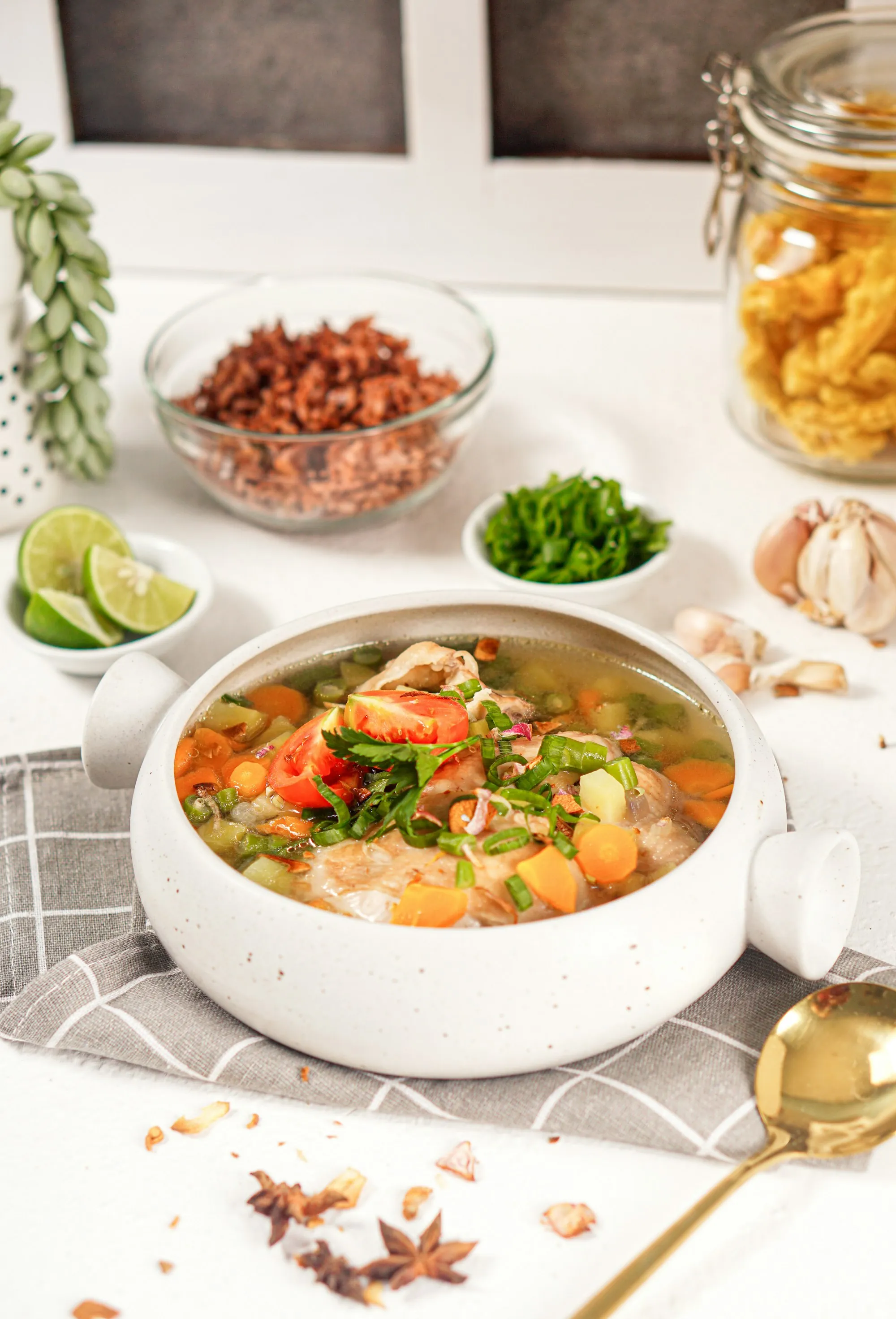 A bowl of soup set out on a kitchen table